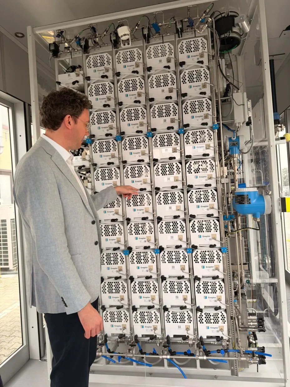Ben Medland examining a rack of Enapter electrolyser modules at Enapter’s Pisa facility