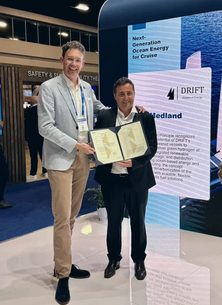 Ben Medland of DRIFT and Patrizio Di Francesco of RINA holding the open Approval in Principle certificate between them at Seatrade Cruise Global in Miami.